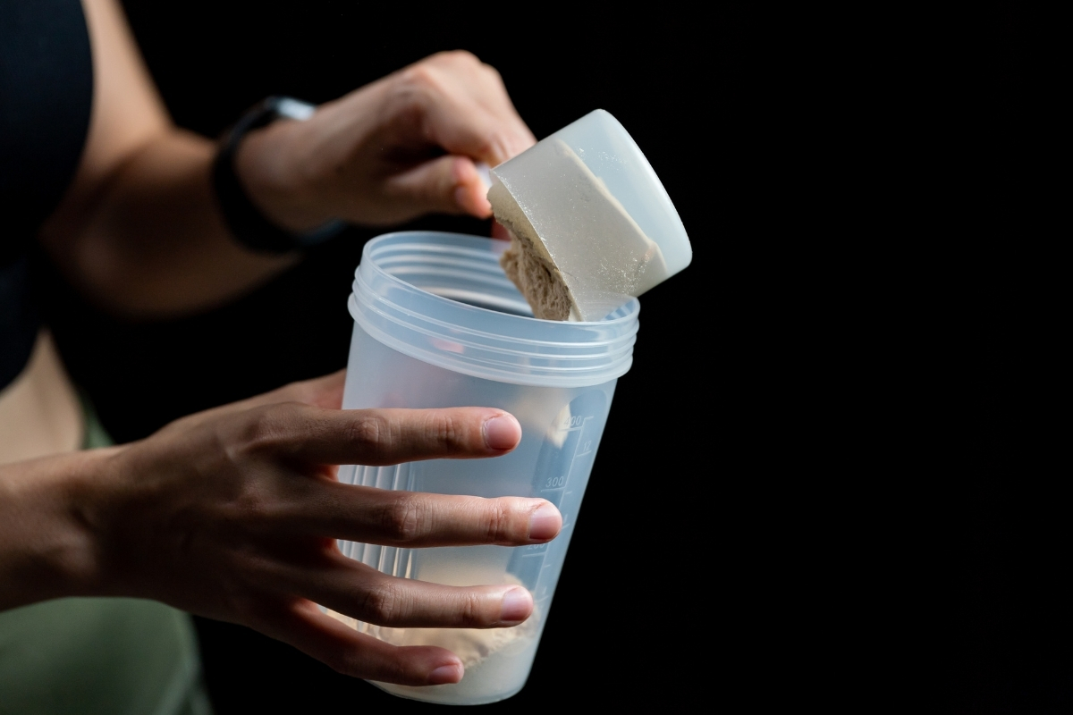 Velositol capsules and a protein shake arranged for an article about dosage and safety